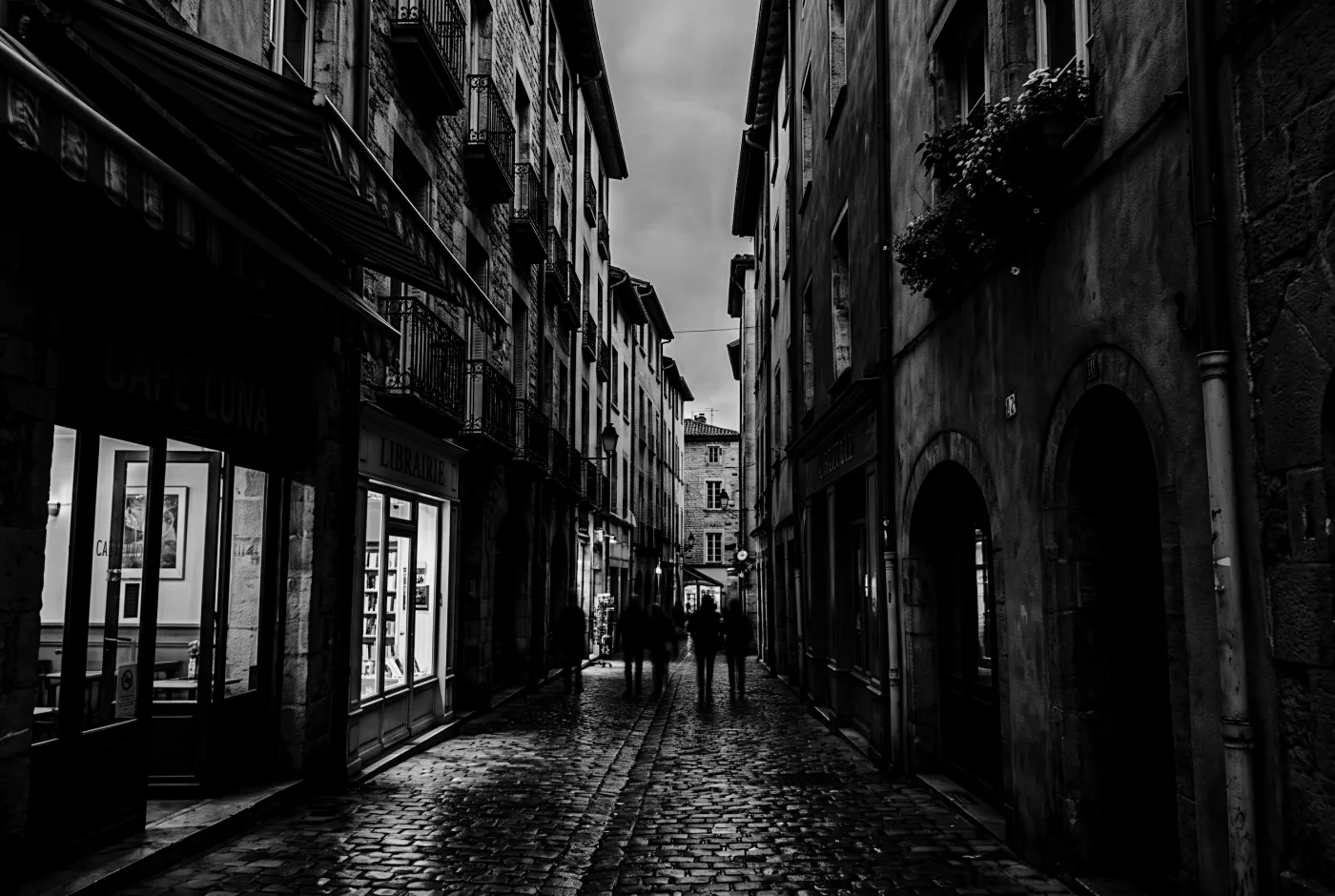 A narrow old town street at dusk, rendered by Lightbox with the Noir Grain preset applied
